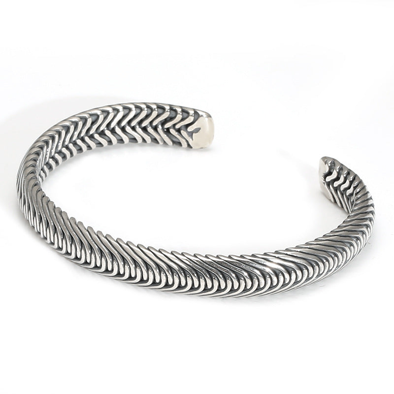 A high-resolution studio product shot of the Nordic Frost Artisan Braided Silver Cuff on a crisp white background. The image showcases the substantial open-ended open cuff design, highlighting the intricate, continuous chevron scale weave and deep oxidized valleys of the solid 925 sterling silver.