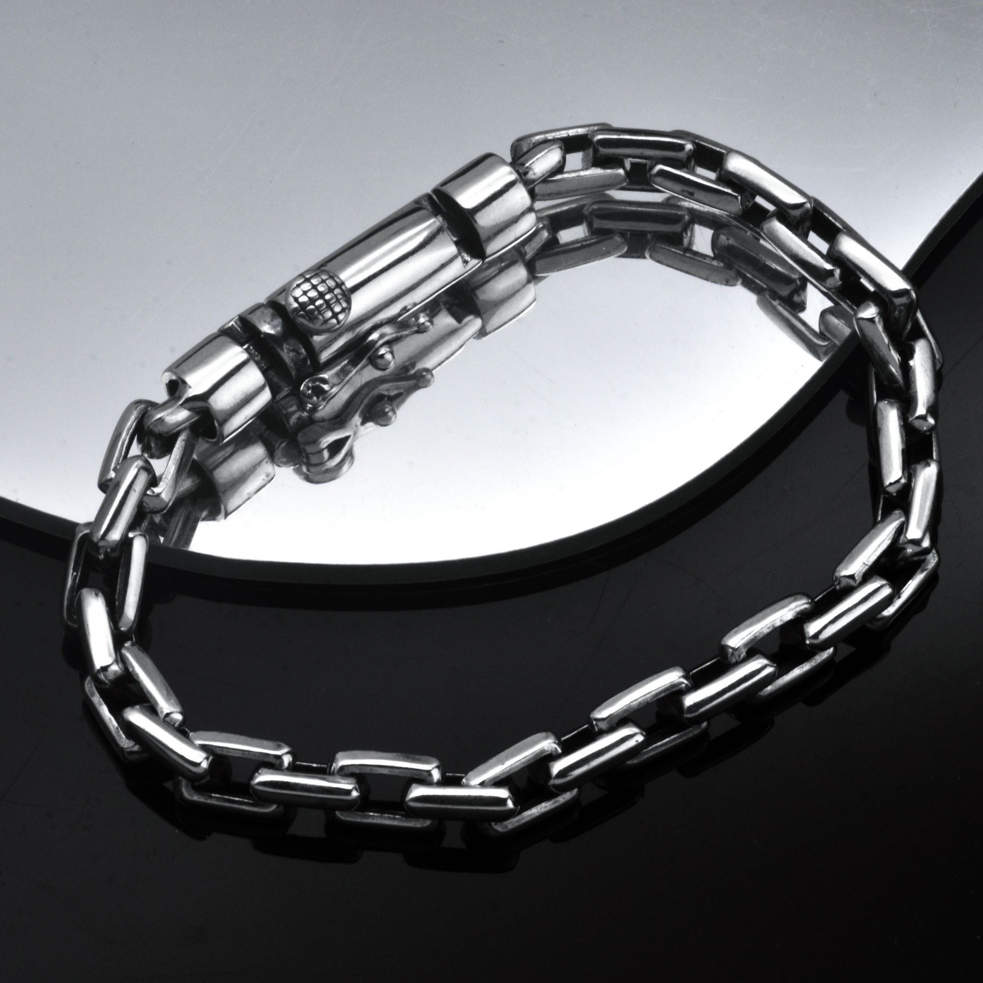 Silver chain bracelet on a reflective surface