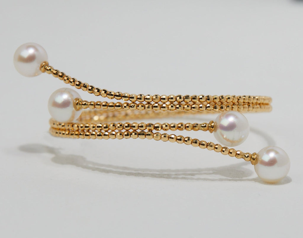 BoxUnboxed 18K yellow gold multi-coil spiral bangle with four Akoya pearls and diamond-faceted beads.
