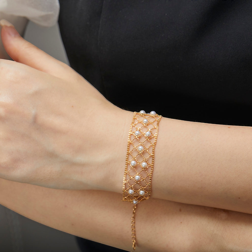 BoxUnboxed 18k yellow gold lace lattice bracelet with Akoya pearls. Adjustable length, secure clasp.