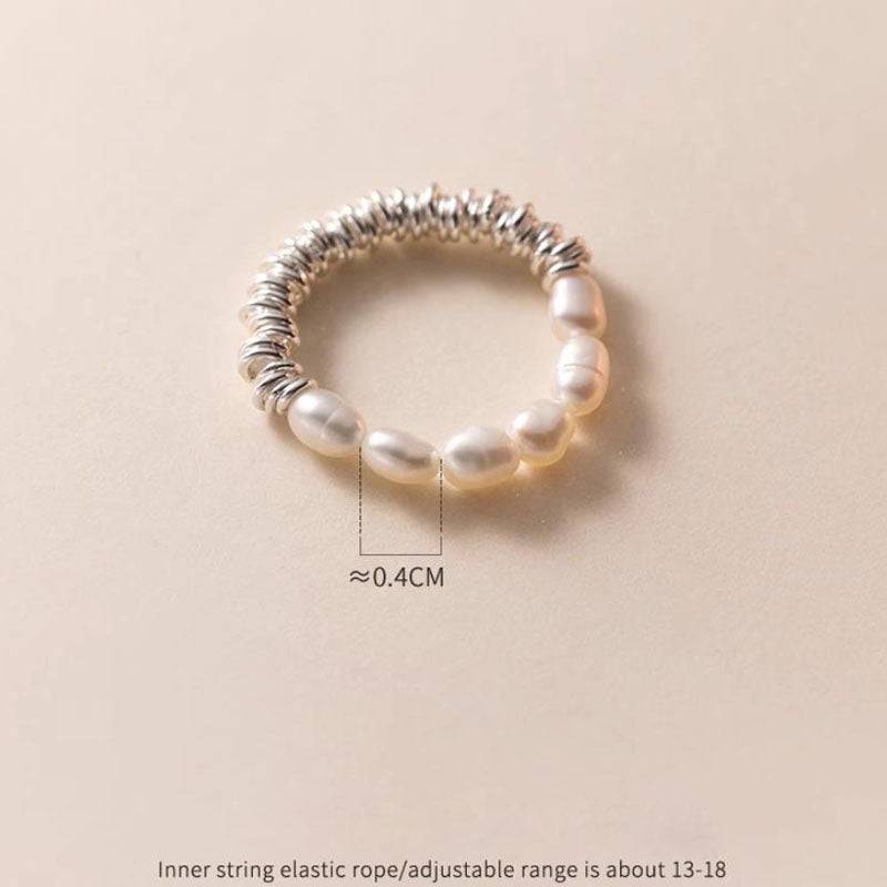 BoxUnboxed ring with baroque pearls and coiled sterling silver band. Features a fluid design and universal fit.