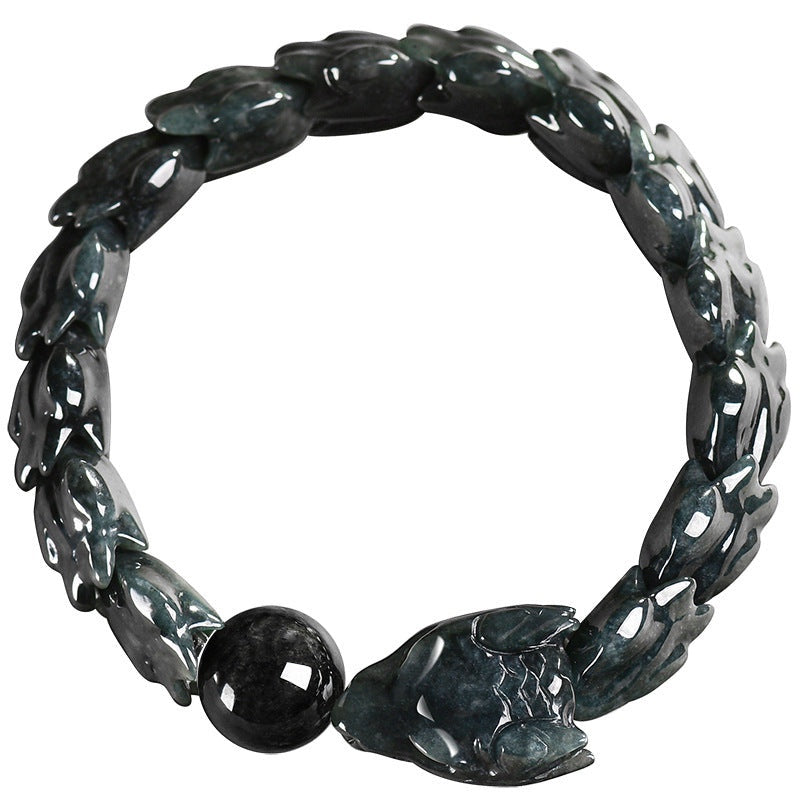 BoxUnboxed hand-carved jadeite dragon bones bracelet in dark teal and charcoal hues, featuring scale links and a dragon head clasp.