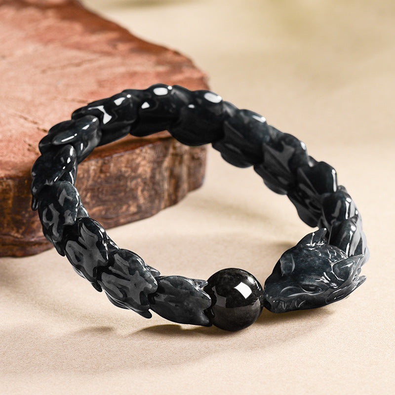 BoxUnboxed hand-carved jadeite dragon bones bracelet in dark teal and charcoal hues with a high-polish focal stone.