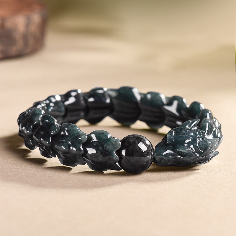BoxUnboxed hand-carved jadeite dragon bones bracelet with interlocking scale segments and a dragon head clasp in deep teal and charcoal.